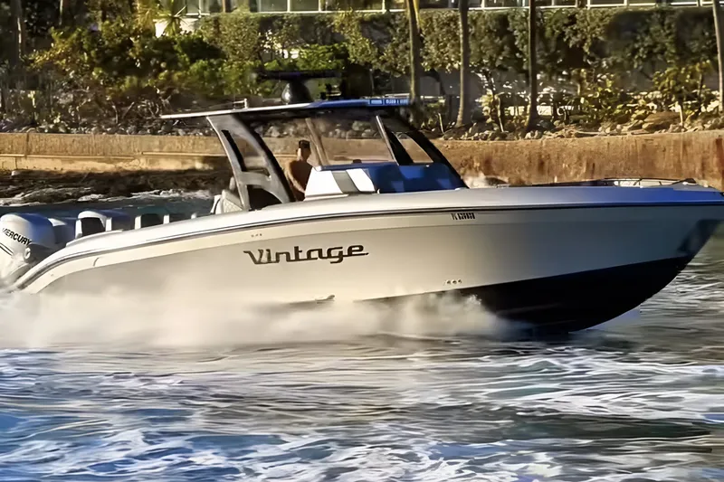 The Image of 2021 Midnight Express 37 Open boat cruising swiftly on water, labeled "Vintage." - 1