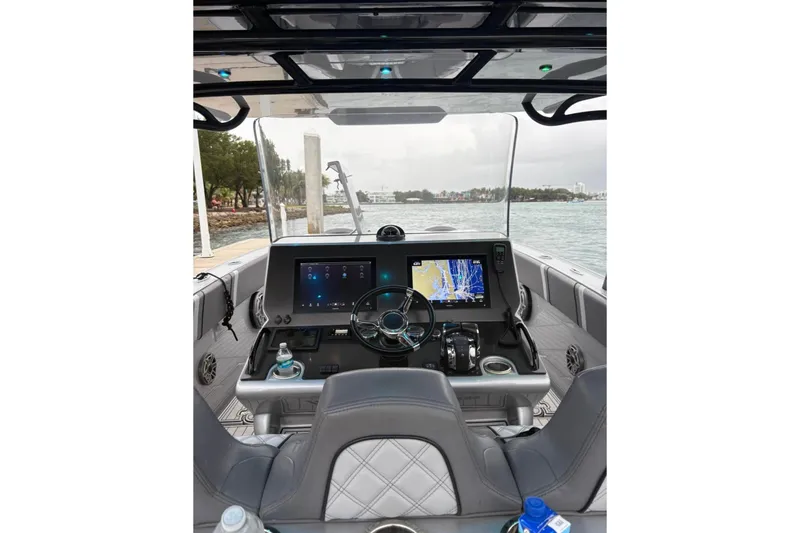 Slide: The Image of Interior view of 2021 Midnight Express 37 Open boat cockpit with navigation screens. - 13