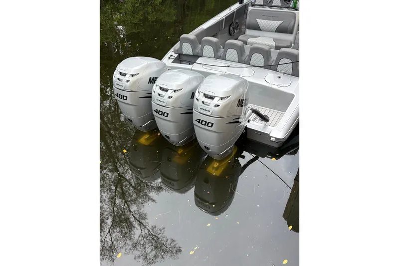Slide: The Image of 2021 Midnight Express 37 Open boat with triple Mercury 400 engines on calm water. - 9