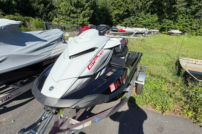 Slide: The Image of 2024 Yamaha WaveRunner GP HO jet ski on trailer, parked outdoors. - 4