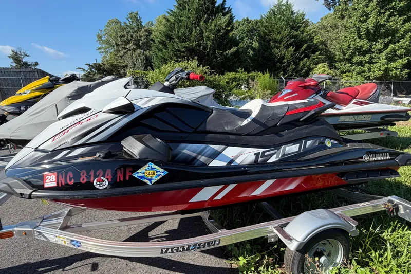The Image of 2024 Yamaha WaveRunner GP HO jet ski on a trailer, parked outdoors. - 0