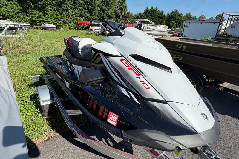 Slide: The Image of 2024 Yamaha WaveRunner GP HO jet ski on trailer, parked outdoors. - 2