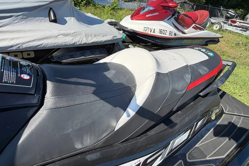 Slide: The Image of 2024 Yamaha WaveRunner GP HO jet ski with sleek black and white seat design. - 6