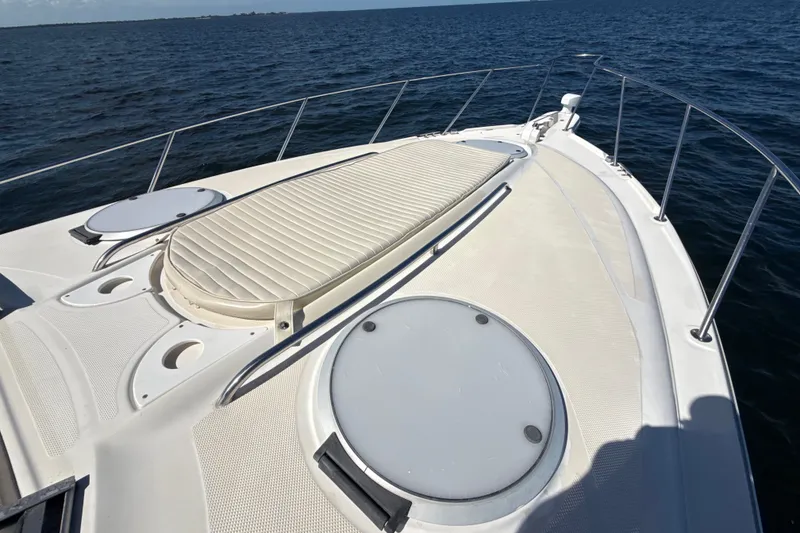 Slide: The Image of 1999 Maxum 3300 SCR boat deck with sun pad, cruising on open water. - 57