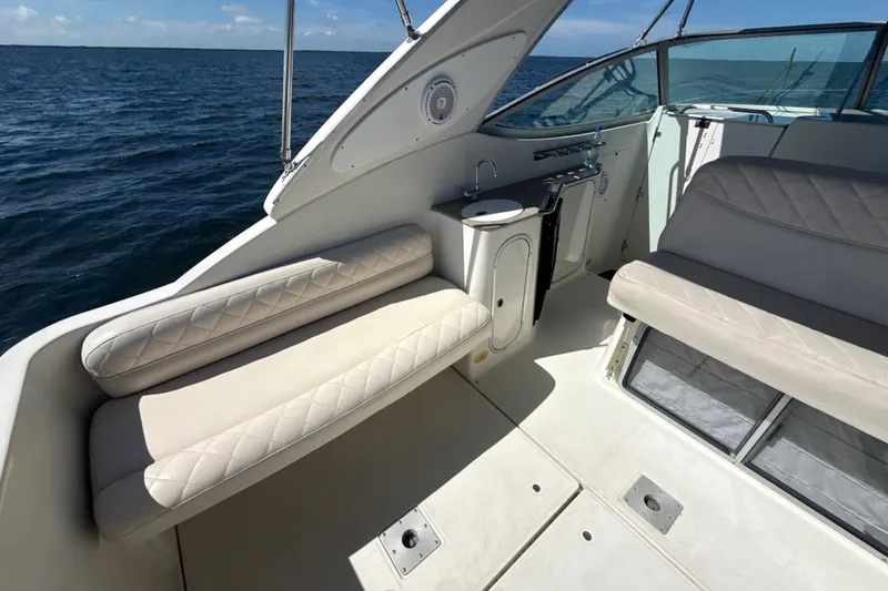 Slide: The Image of 1999 Maxum 3300 SCR boat interior with cushioned seating and ocean view. - 13