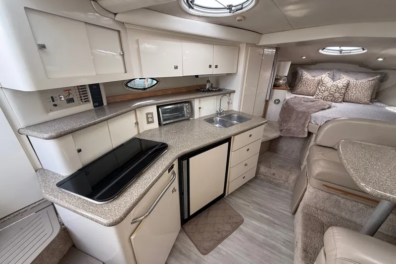 Slide: The Image of Luxurious interior of a 1999 Maxum 3300 SCR yacht with modern kitchen and cozy sleeping area. - 31