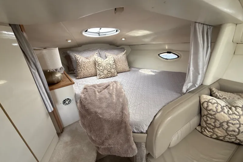 Slide: The Image of Luxurious cabin interior of 1999 Maxum 3300 SCR yacht with plush bedding and elegant decor. - 39