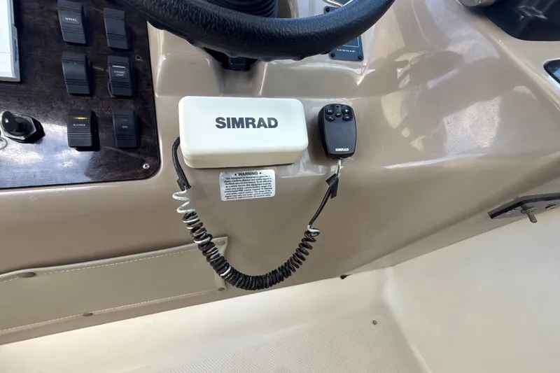 Slide: The Image of 1999 Maxum 3300 SCR dashboard with Simrad marine electronics and control panel. - 23