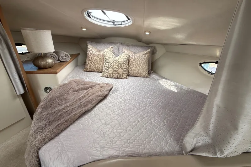 Slide: The Image of Luxurious cabin interior of 1999 Maxum 3300 SCR yacht with plush bedding and elegant decor. - 40