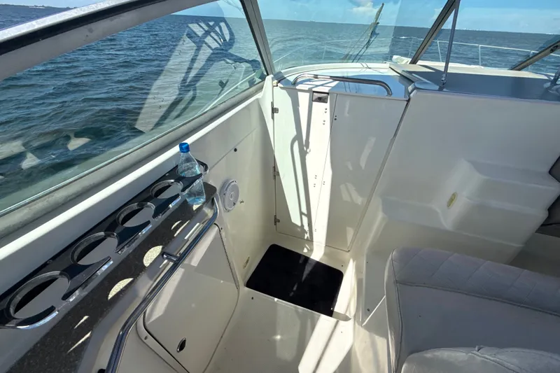 Slide: The Image of 1999 Maxum 3300 SCR boat interior with cup holders and ocean view. - 26