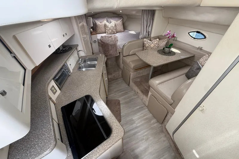 Slide: The Image of Interior of 1999 Maxum 3300 SCR yacht with kitchen and seating area. - 28