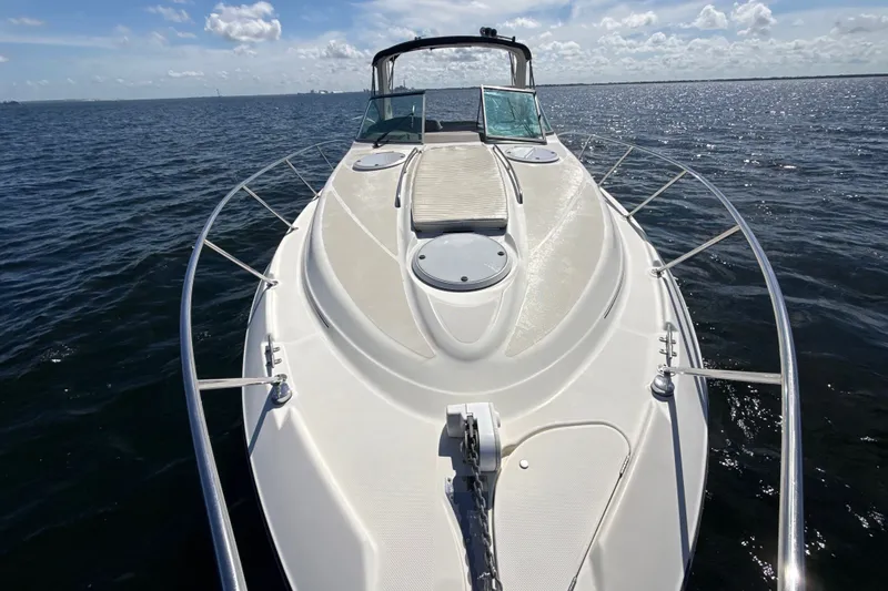 Slide: The Image of 1999 Maxum 3300 SCR boat cruising on open water under a clear sky. - 60