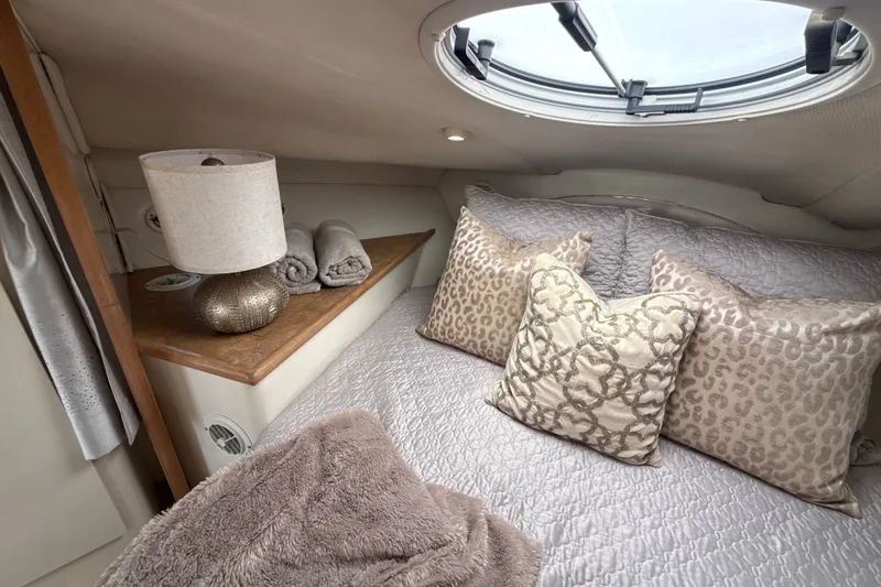 Slide: The Image of Cozy cabin interior of 1999 Maxum 3300 SCR with plush bedding and elegant decor. - 41