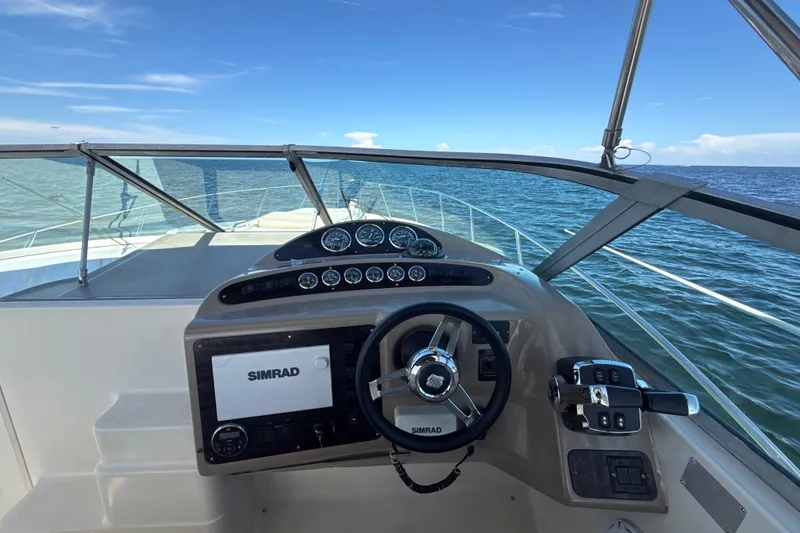 Slide: The Image of Helm of 1999 Maxum 3300 SCR boat with Simrad navigation, overlooking open sea. - 20