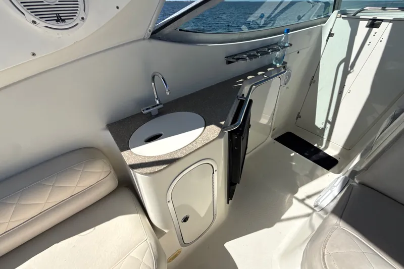 Slide: The Image of 1999 Maxum 3300 SCR boat interior with sink, counter, and seating. - 14