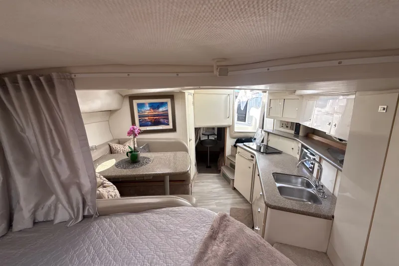 Slide: The Image of Interior of 1999 Maxum 3300 SCR yacht with kitchen, dining area, and cozy seating. - 42