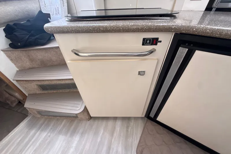 Slide: The Image of 1999 Maxum 3300 SCR interior showing kitchen counter and steps. - 37
