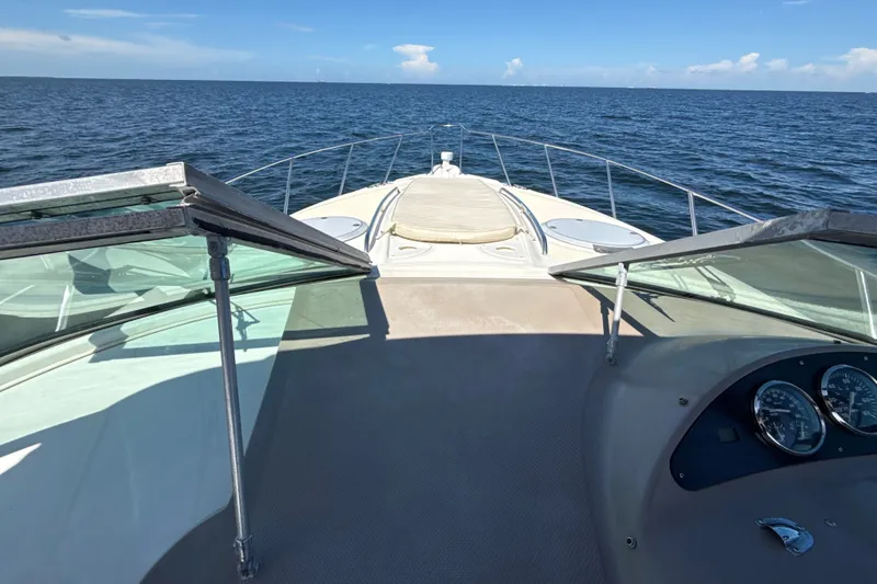 Slide: The Image of 1999 Maxum 3300 SCR yacht cruising on open sea under clear blue sky. - 55