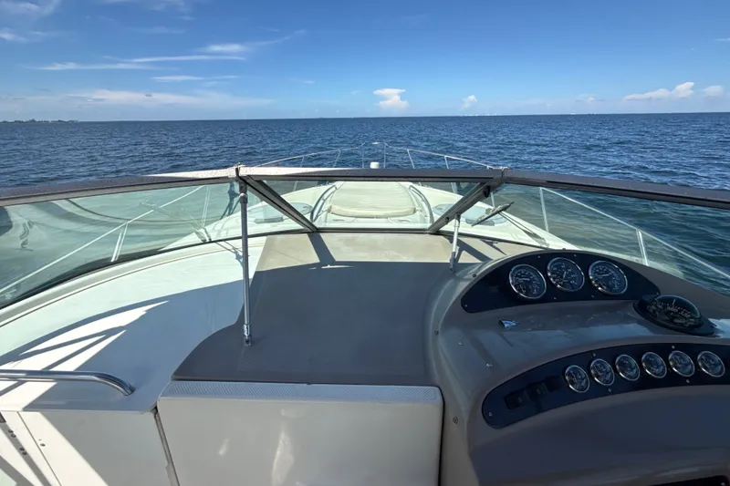 Slide: The Image of 1999 Maxum 3300 SCR boat dashboard with ocean view under clear blue sky. - 54