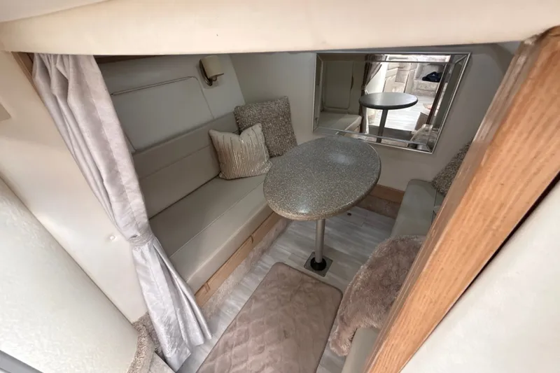 Slide: The Image of Interior of 1999 Maxum 3300 SCR boat with cozy seating and table. - 52