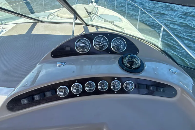 Slide: The Image of Dashboard of a 1999 Maxum 3300 SCR boat with gauges and compass. - 21