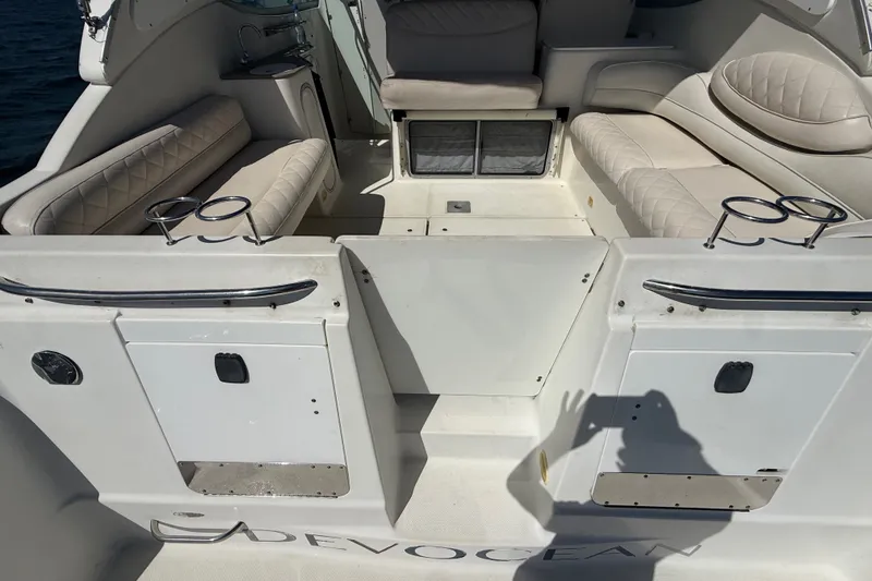 Slide: The Image of 1999 Maxum 3300 SCR boat interior with cushioned seating and cup holders. - 8