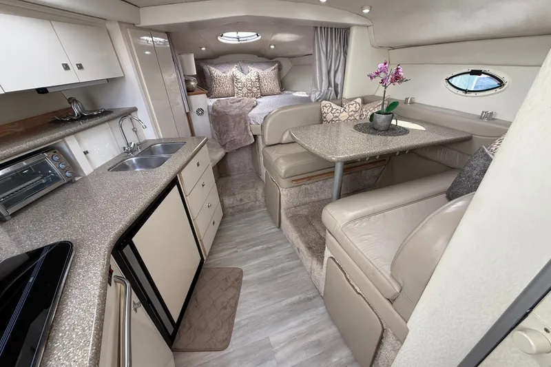 Slide: The Image of Luxurious interior of a 1999 Maxum 3300 SCR yacht with kitchen and cozy seating area. - 29