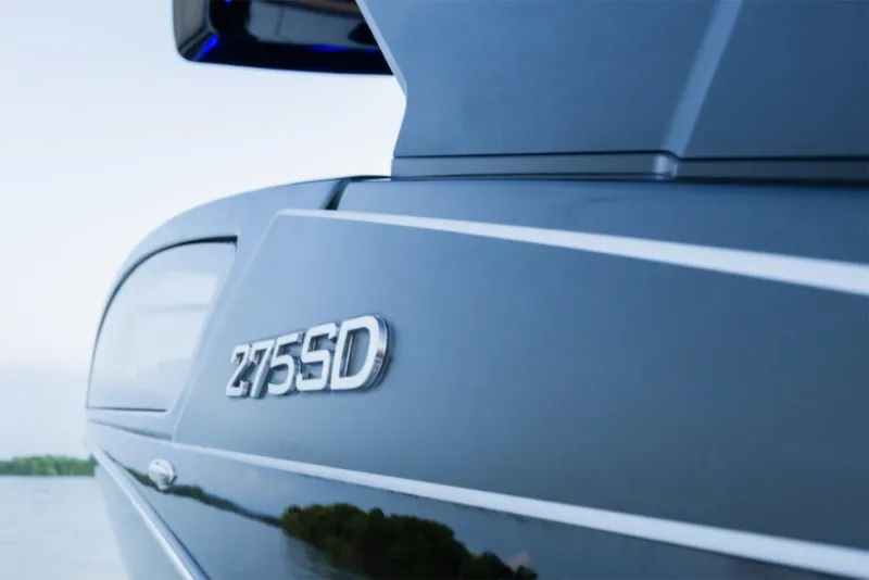 Slide: The Image of Manufacturer Provided Image: 2025 Yamaha Boats 275SD close-up on water, showcasing sleek design and model emblem. - 4