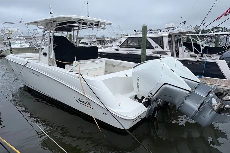 The Image of 2006 Boston Whaler 320 Outrage boat docked, featuring twin Mercury engines. - 0