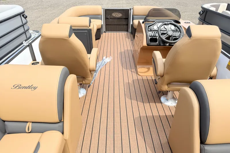 Slide: The Image of 2027 Bentley Pontoons Legacy 220 Navigator interior with tan seating and modern helm controls. - 18