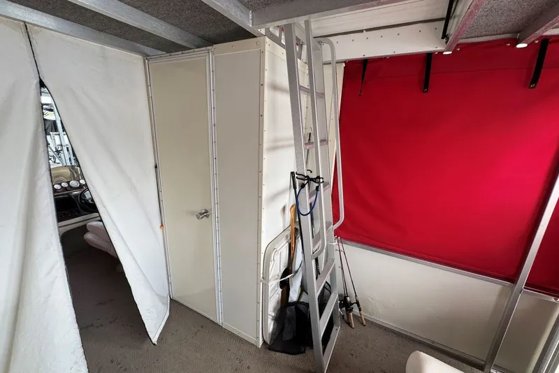 Slide: The Image of Interior of 2008 Sun Tracker Party Hut 30 I/O Regency Edition with ladder and red curtain. - 25