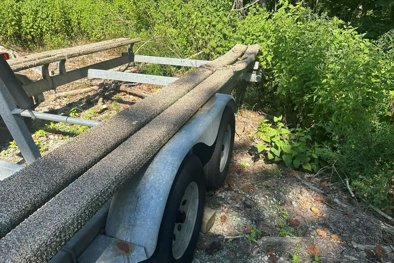 Slide: The Image of Trailer for 2008 Sun Tracker Party Hut 30 I/O Regency Edition, parked in a wooded area. - 39