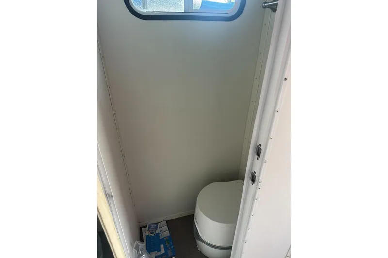 Slide: The Image of Compact bathroom in 2008 Sun Tracker Party Hut 30 I/O Regency Edition boat. - 26