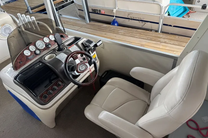 Slide: The Image of 2008 Sun Tracker Party Hut 30 I/O Regency Edition helm with gauges and captain's chair. - 14