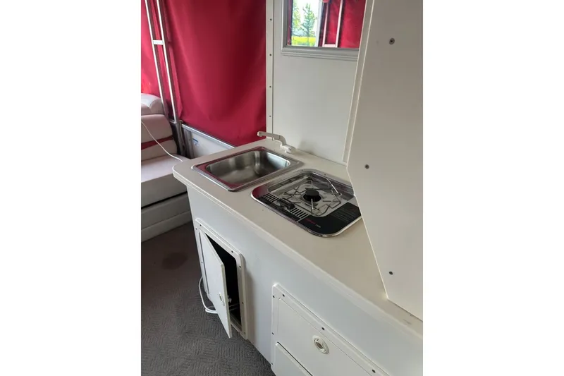 Slide: The Image of 2008 Sun Tracker Party Hut 30 I/O Regency Edition interior with kitchenette and red curtains. - 23
