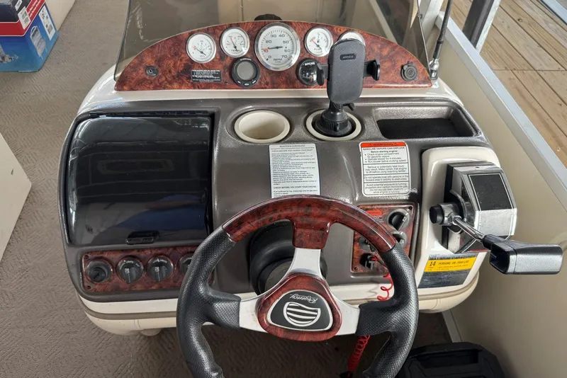 Slide: The Image of 2008 Sun Tracker Party Hut 30 I/O Regency Edition dashboard with steering wheel and controls. - 16