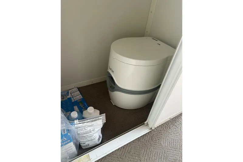 Slide: The Image of Portable toilet inside 2008 Sun Tracker Party Hut 30 I/O Regency Edition boat. - 27