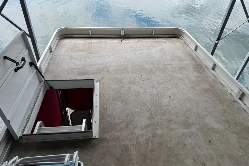 Slide: The Image of 2008 Sun Tracker Party Hut 30 I/O Regency Edition deck with open hatch and water view. - 32