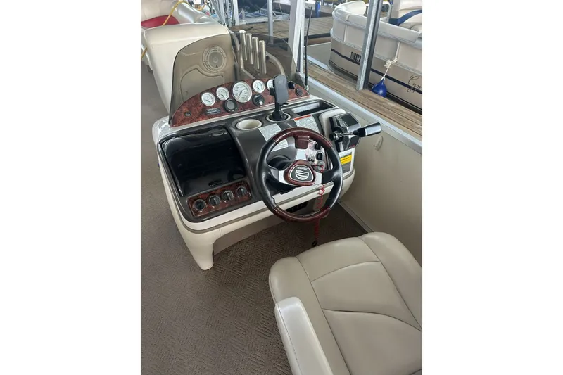 Slide: The Image of 2008 Sun Tracker Party Hut 30 I/O Regency Edition boat dashboard with steering wheel and gauges. - 15