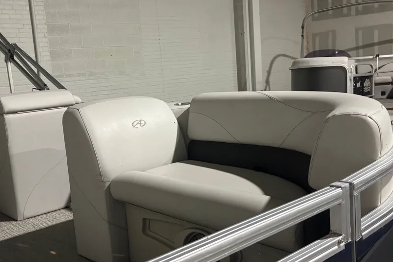 Slide: The Image of 2024 Avalon VLS Quad Lounge boat interior with plush seating and sleek design. - 10
