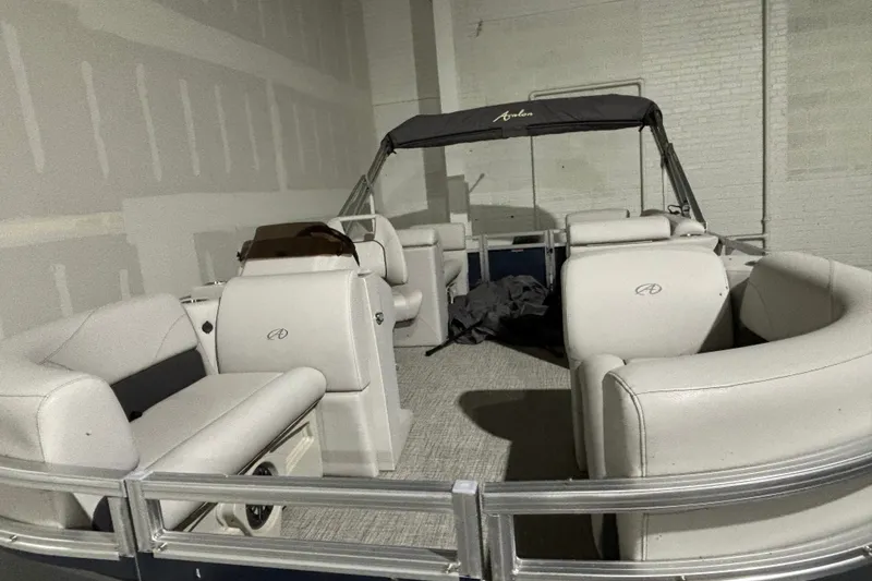 Slide: The Image of 2024 Avalon VLS Quad Lounge 19' pontoon boat interior with plush seating. - 4