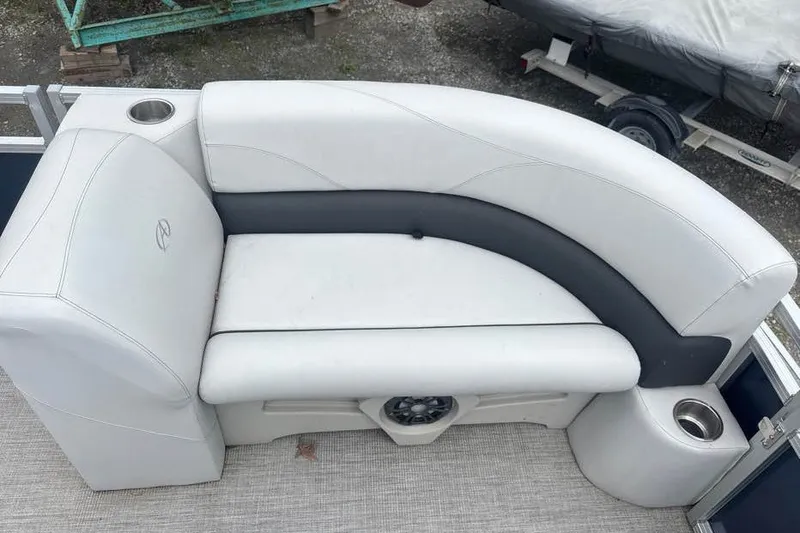 Slide: The Image of 2024 Avalon VLS Quad Lounge boat seating with cup holders and speaker. - 6