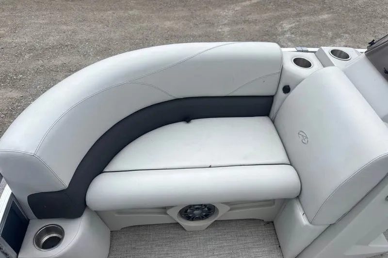 Slide: The Image of 2024 Avalon VLS Quad Lounge boat seating with cup holders and speaker. - 7