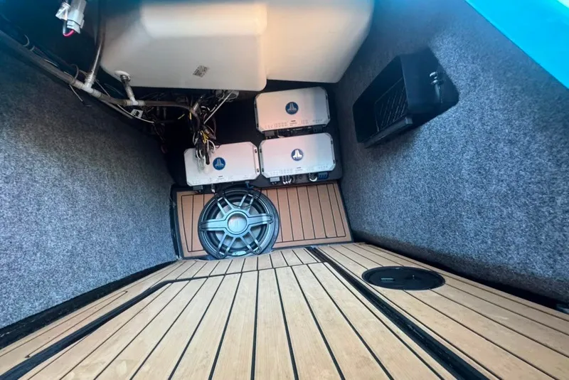 Slide: The Image of Interior view of 2022 Nautique Super Air Nautique G23 with audio equipment and wooden flooring. - 66