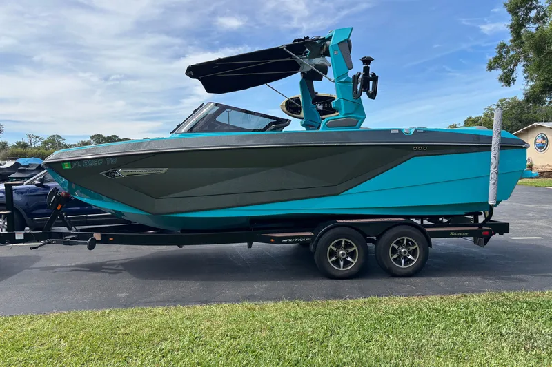 Slide: The Image of 2022 Nautique Super Air Nautique G23 boat on trailer, vibrant blue color. - 11