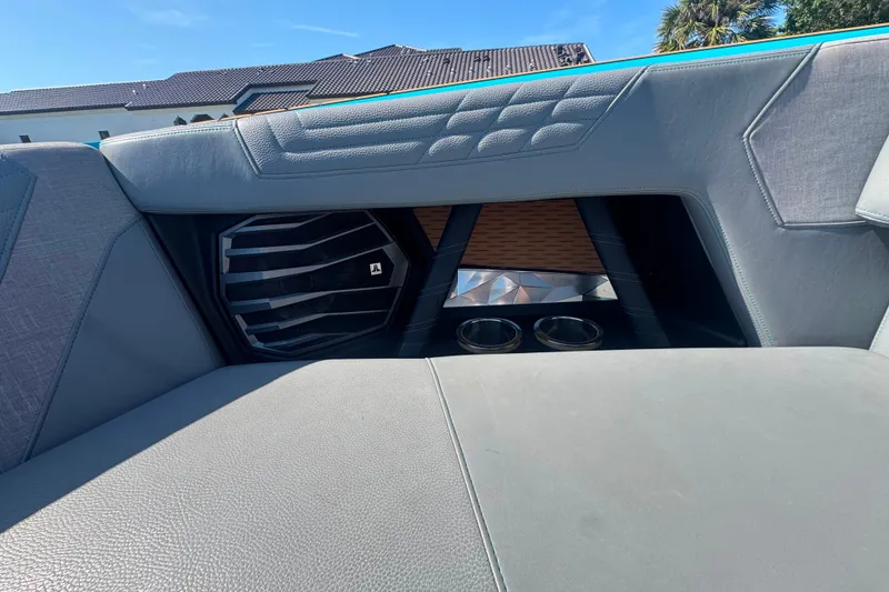 Slide: The Image of 2022 Nautique Super Air Nautique G23 interior with speaker and cup holders. - 40