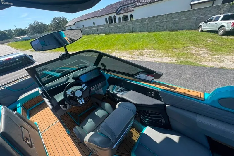 Slide: The Image of Interior of 2022 Nautique Super Air Nautique G23 boat with modern dashboard and seating. - 82