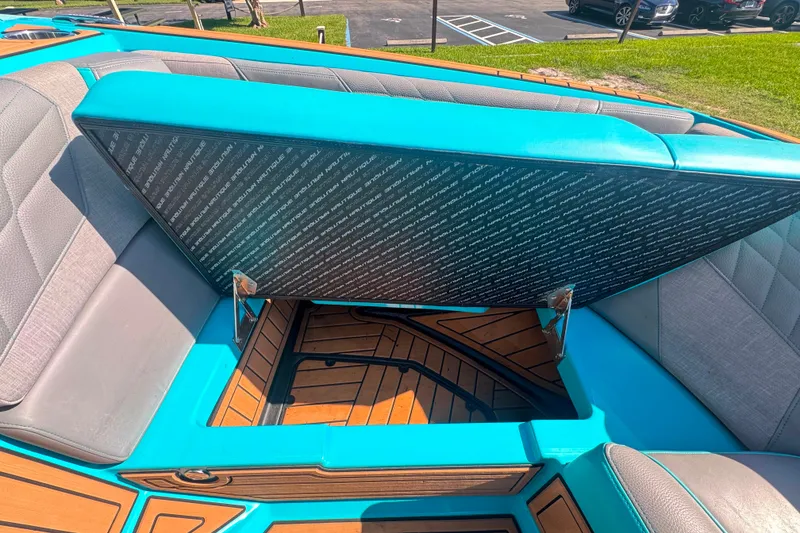 Slide: The Image of 2022 Nautique Super Air Nautique G23 boat interior with open storage compartment. - 118