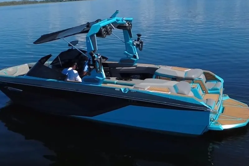 Slide: The Image of 2022 Nautique Super Air Nautique G23 boat on calm water, featuring sleek design and vibrant colors. - 116