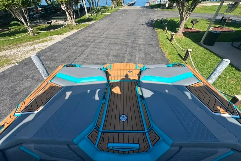 Slide: The Image of 2022 Nautique Super Air Nautique G23 boat on a sunny lakeside dock. - 90